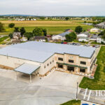 aerial view of metal roof on new office space and attached warehouse