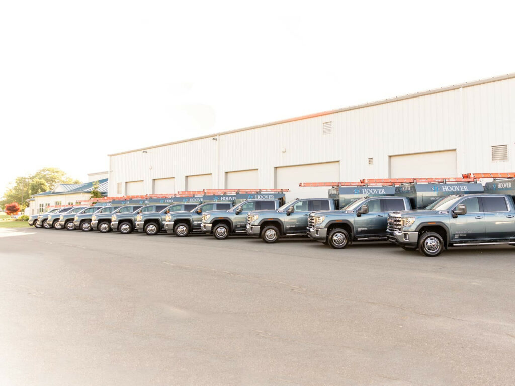 The line of Hoover Building Specialist trucks in front of the shop