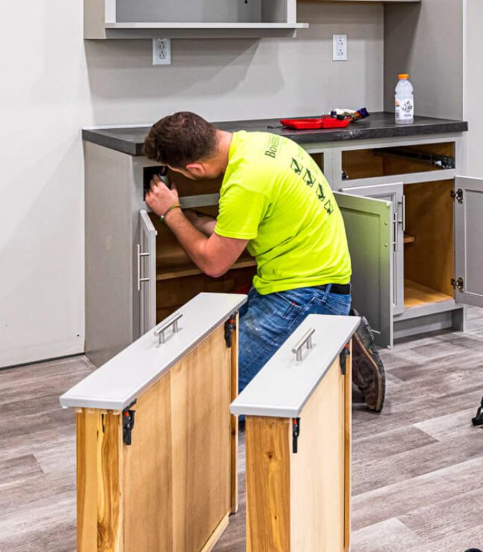 Man installing kitchen cabinets