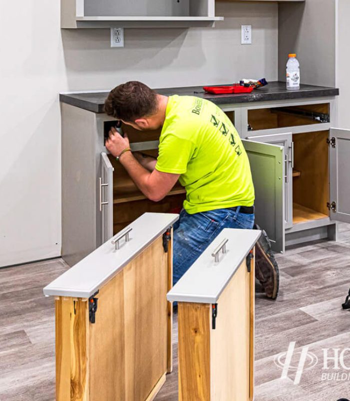 Man installing kitchen cabinets