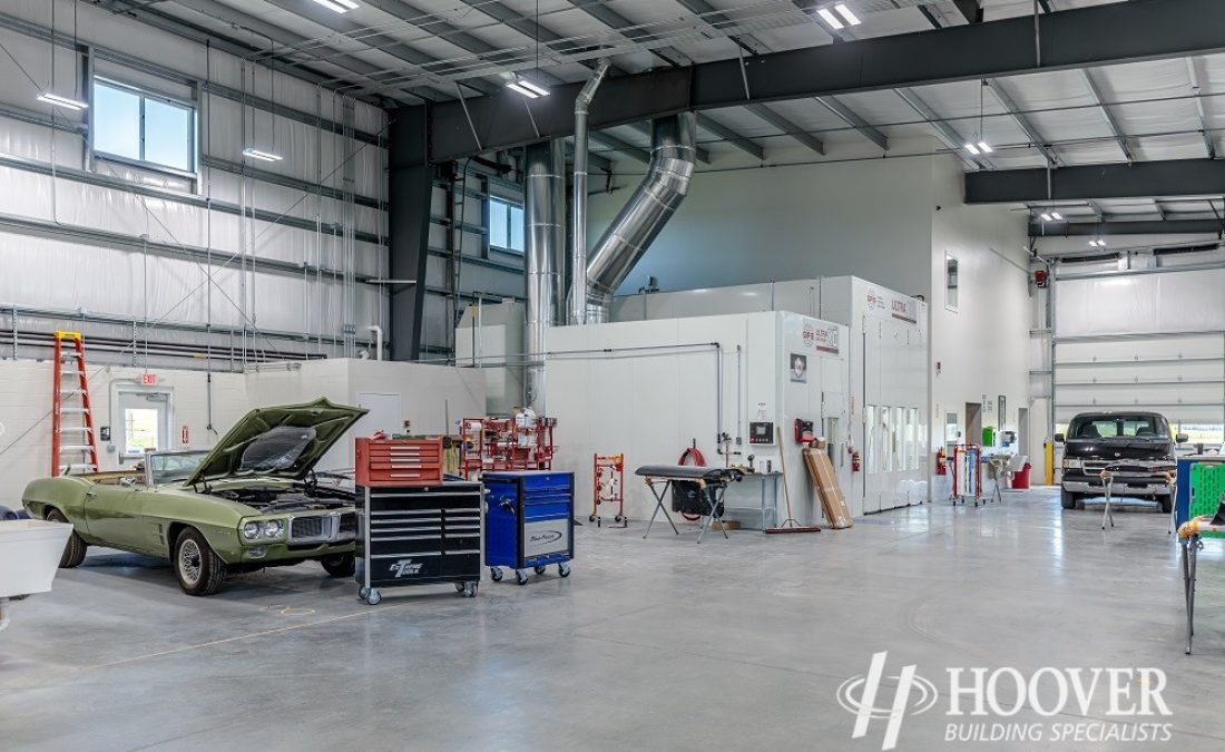 interior shot of completed body shop garage with cement floors and steel beam ceilings