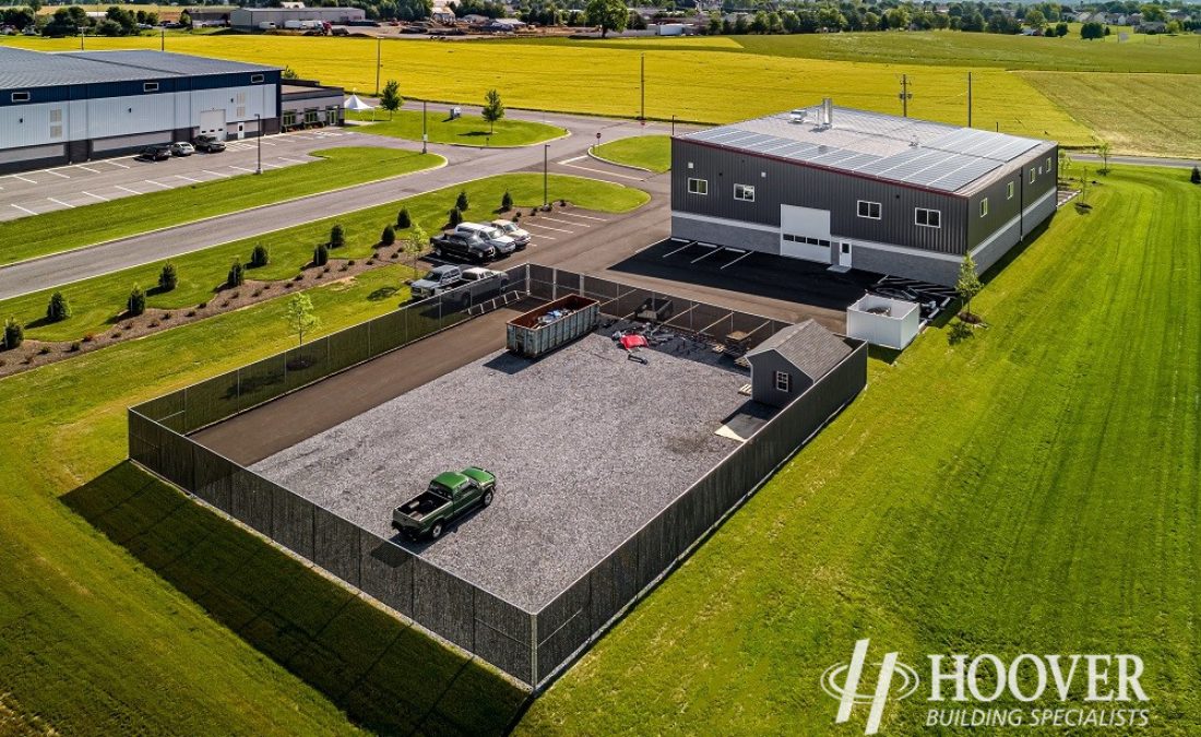 back view of completed body shop with fenced in gravel pit