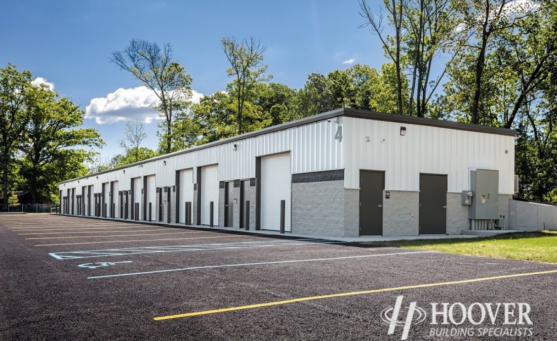 side view of half stone half steel storage building