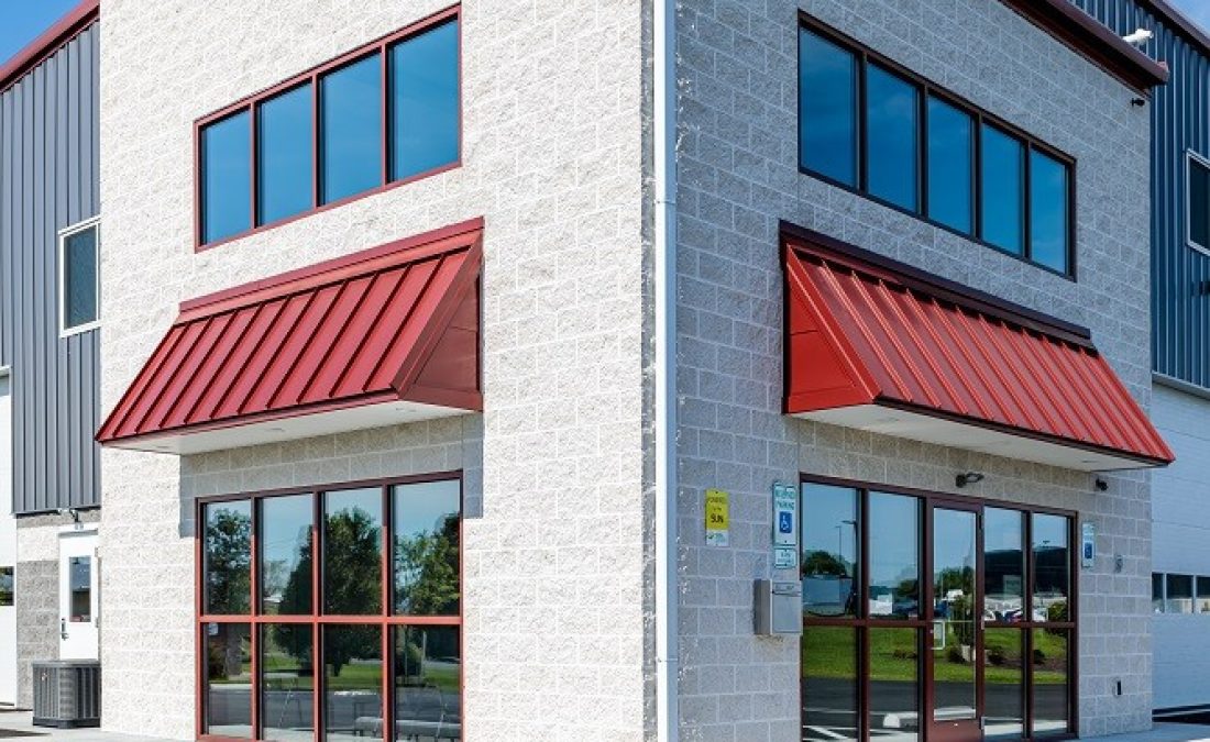 close up of completed stone building with metal overhangs