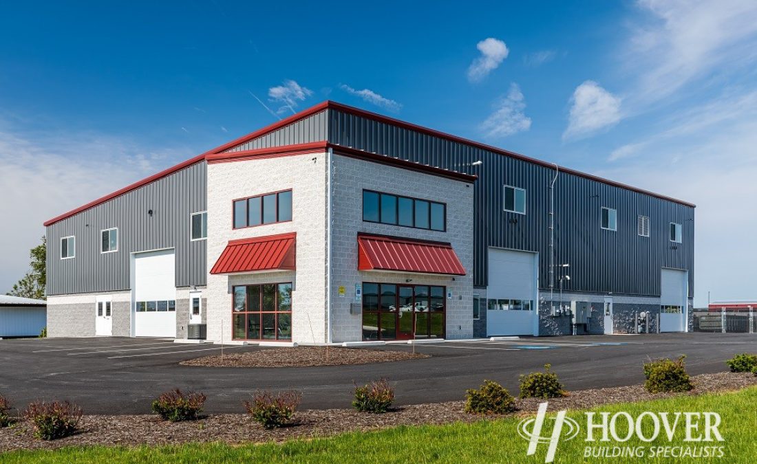 closer photo of commercial body shop project with red metal roofing