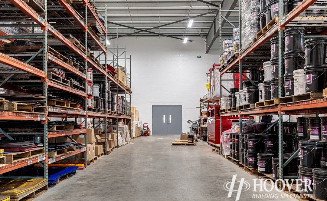 view of completed warehouse with cement floor and warehouse supplies