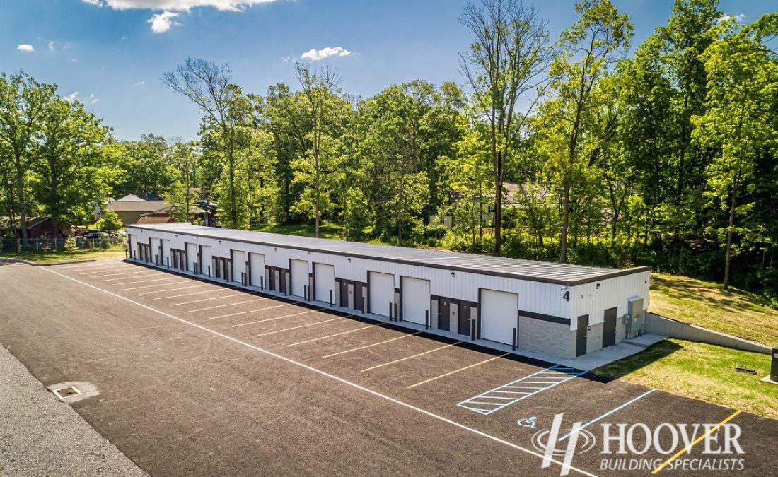 aerial shot of completed long steel building and paved parking lot